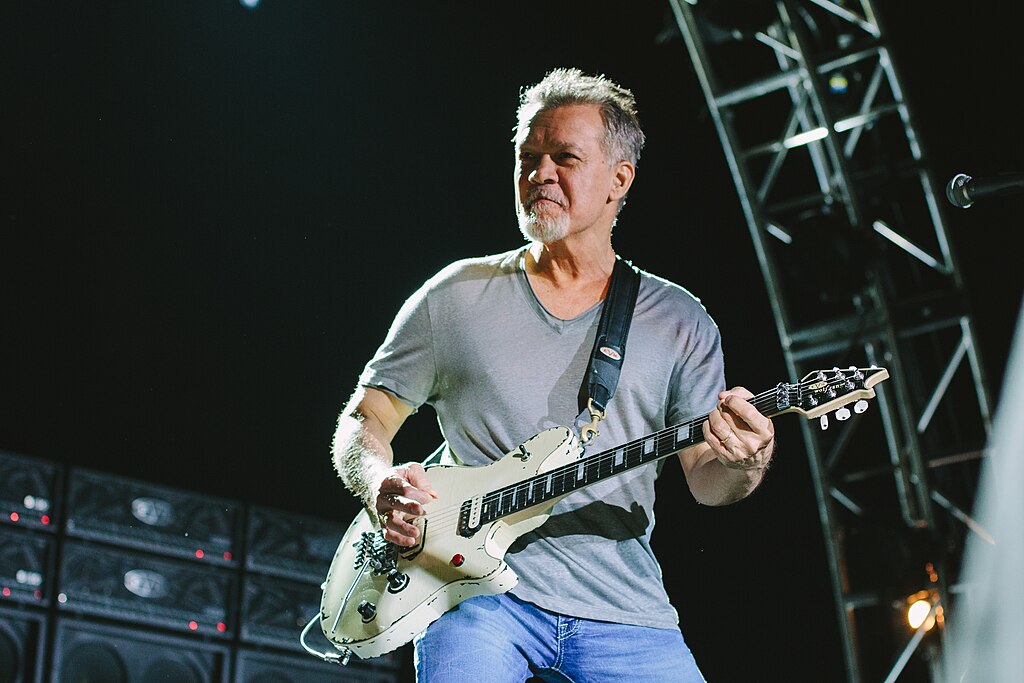 Portrait Photo of Eddie Van Halen performing on stage with his guitar