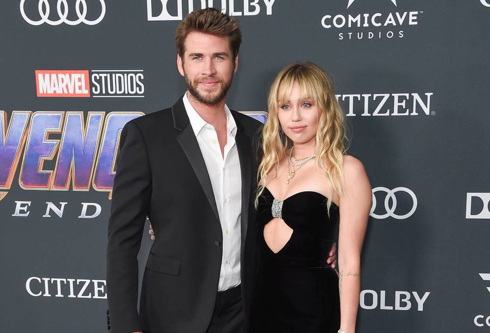 Liam Hemsworth and Miley Cyrus at a premiere