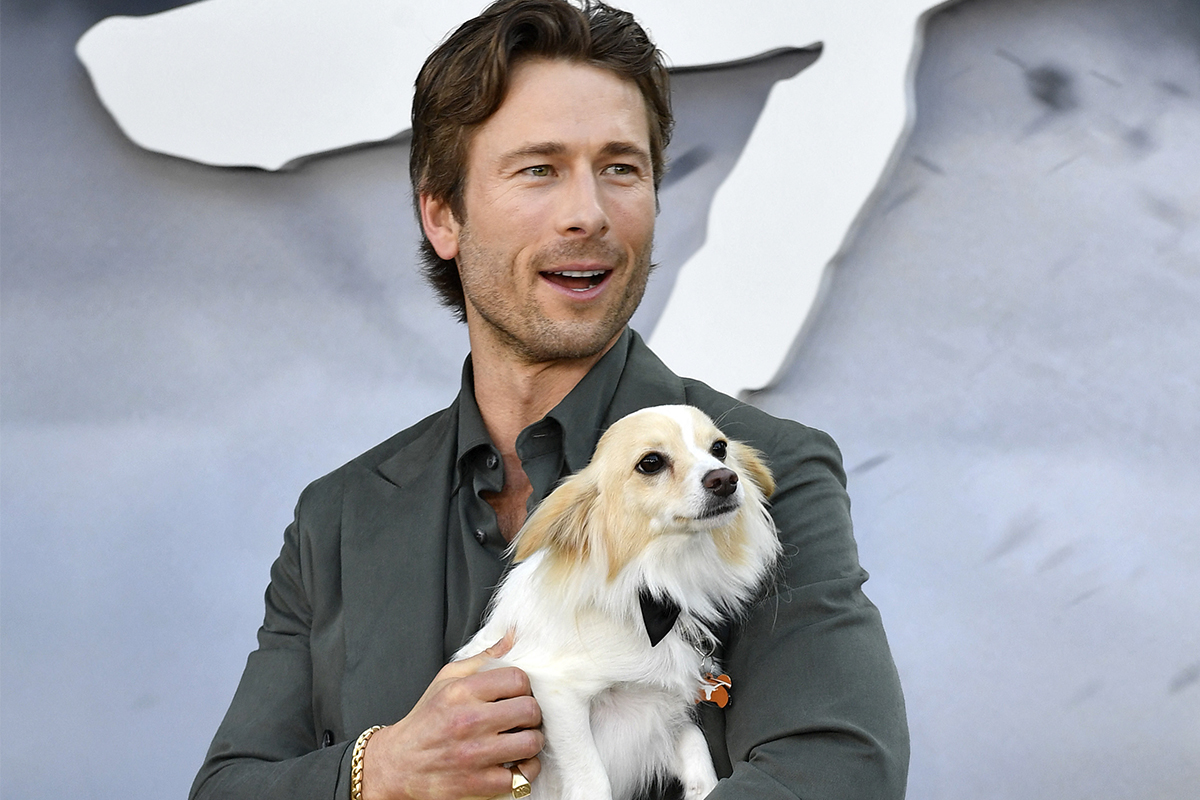 US actor Glen Powell and his dog Brisket attend Universal's