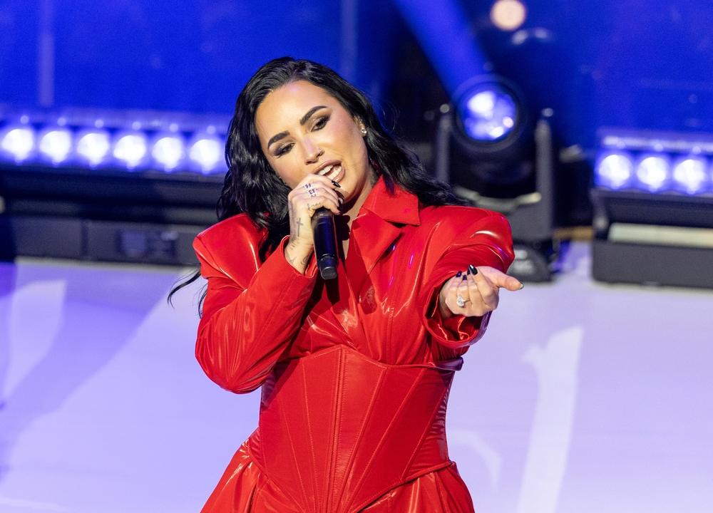 Demi Lovato performs on stage wearing red dress by Michael Ngo