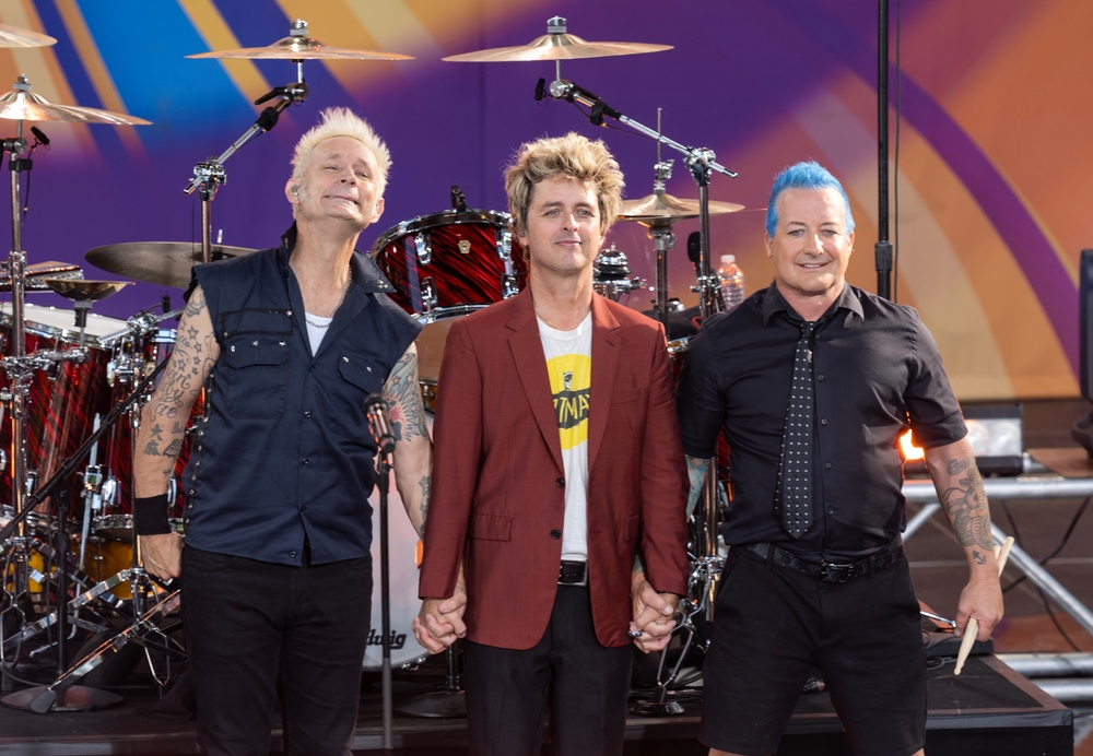 Mike Dirnt, Billie Joe Armstrong, Tre Cool of Green Day pose on stage during ABC Good Morning America