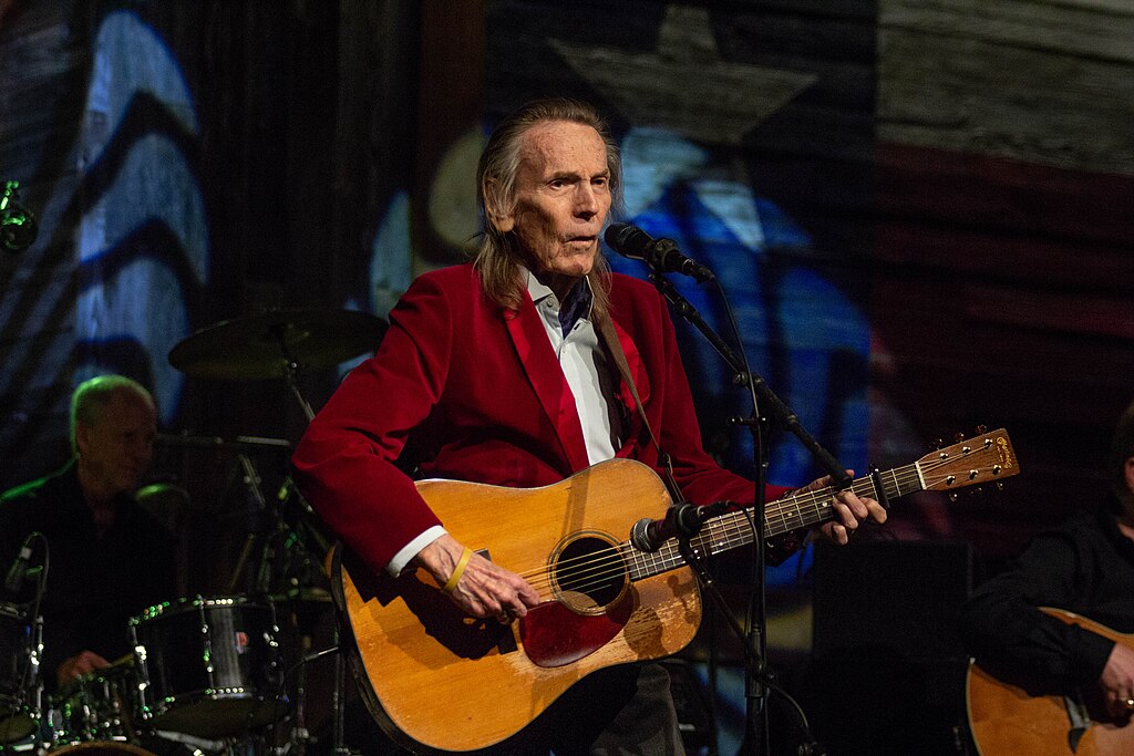 Portrait Photo of Gordon Lightfoot in red outfit performing on stage
