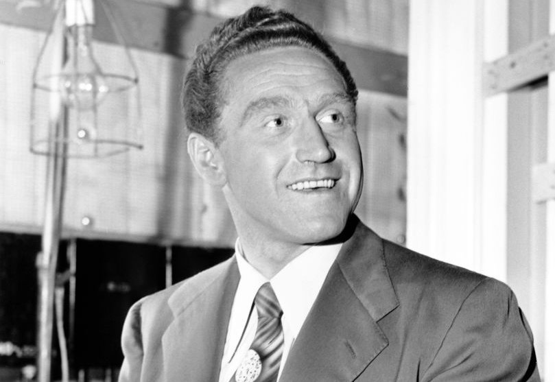James Whitmore wearing a suit