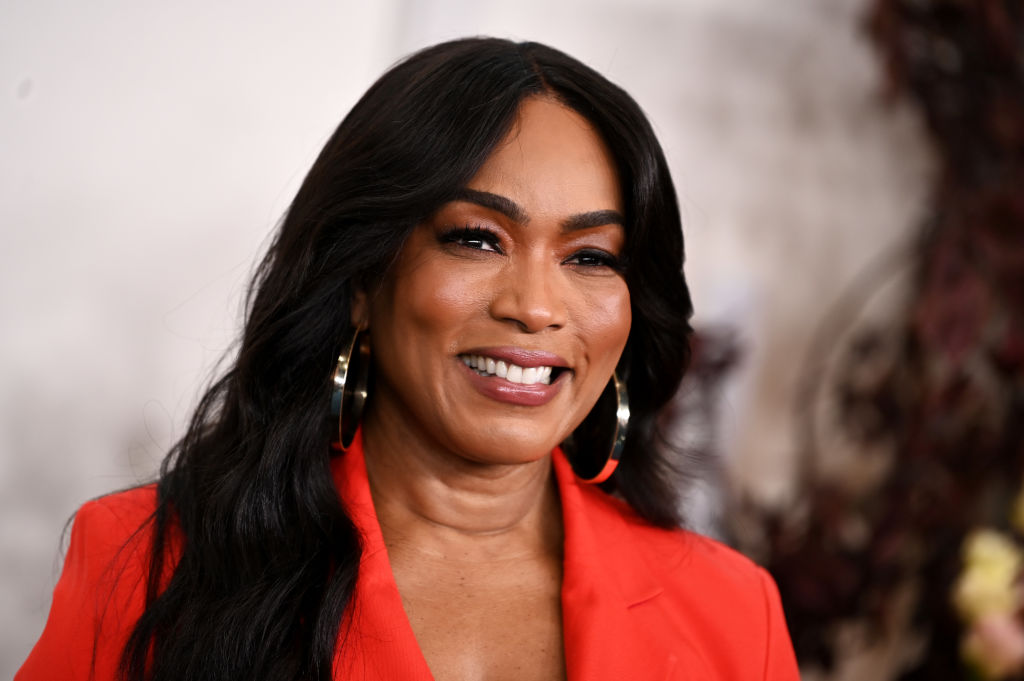 Angela Bassett wearing red jacket