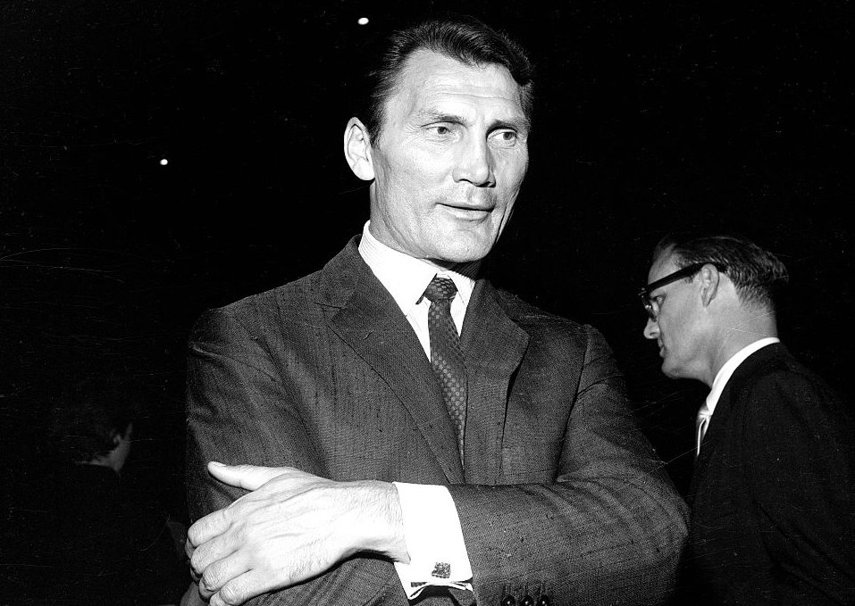 Jack Palance wearing a suit