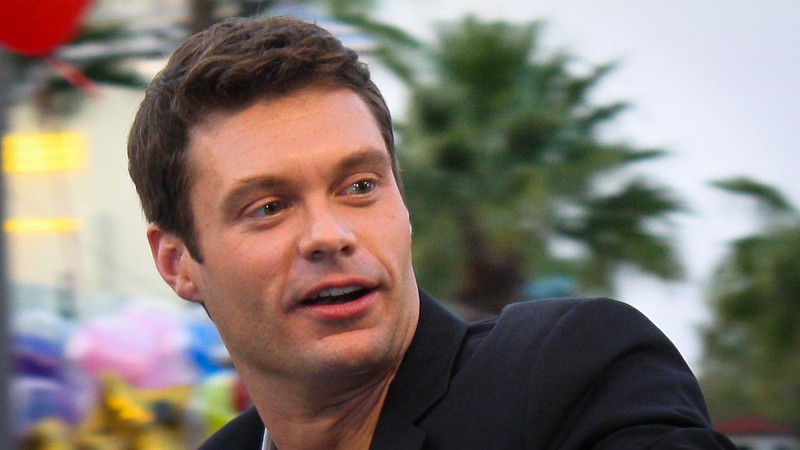 Ryan Seacrest in black jacket
