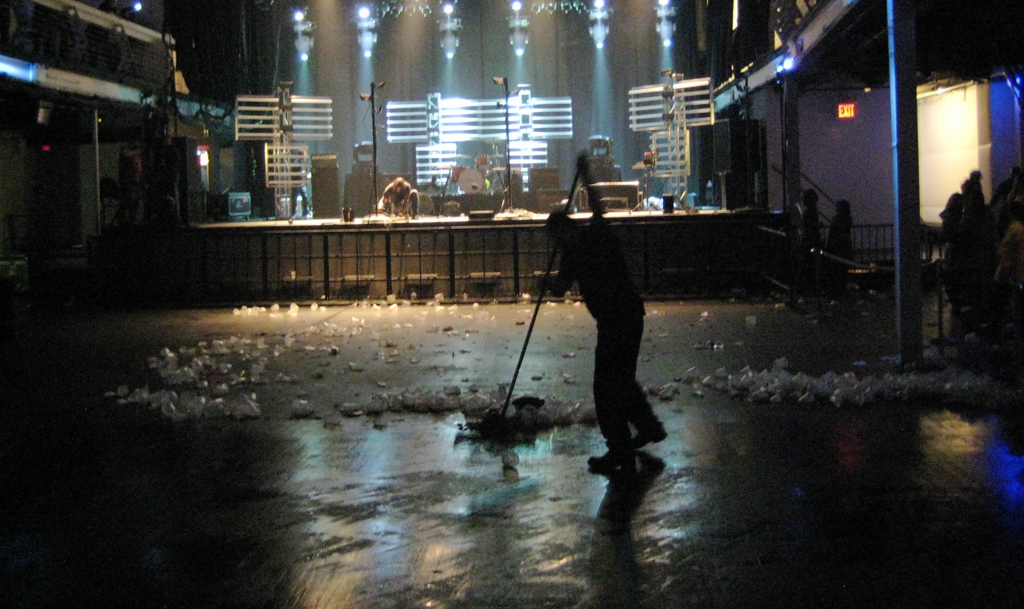 Man sweeps away beer cups