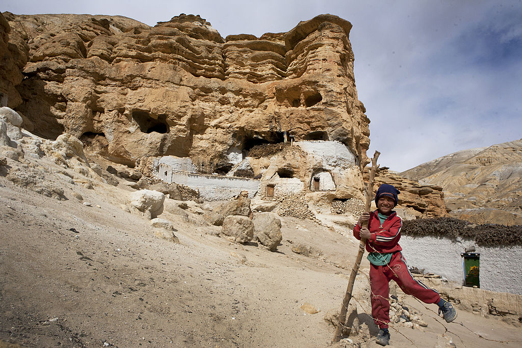 Loba boy next to caves