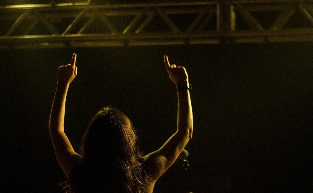 A woman with her hands up