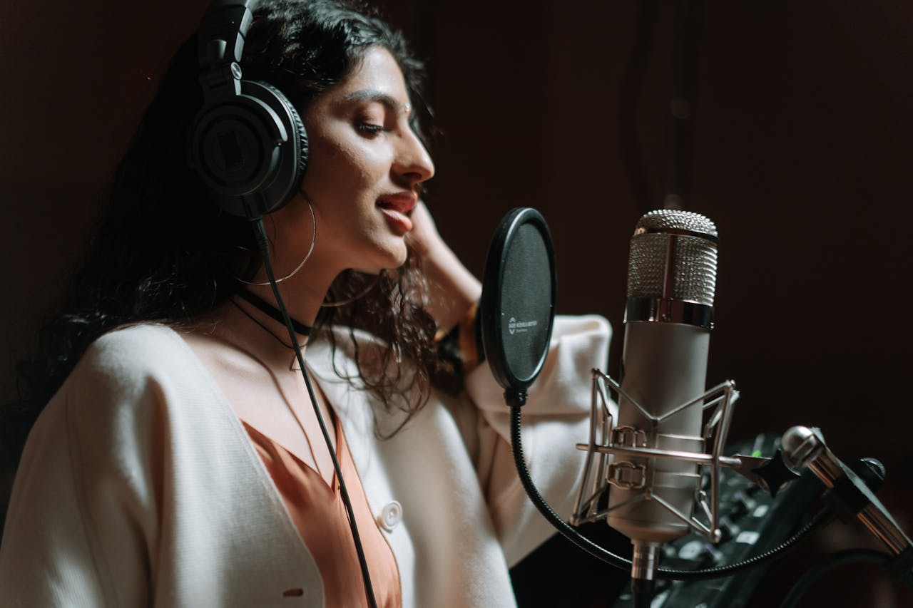 A woman recording a song in a music studio