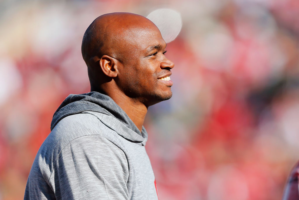 Adrian Peterson in a gray shirt