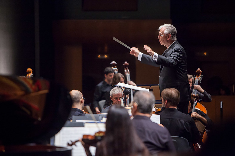 Portrait Photo of Composer Bruce Broughton conducting with orchestra