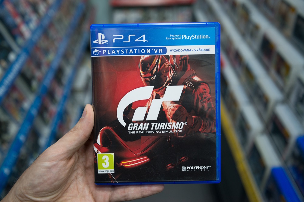 Man holding Gran Turismo Sport videogame