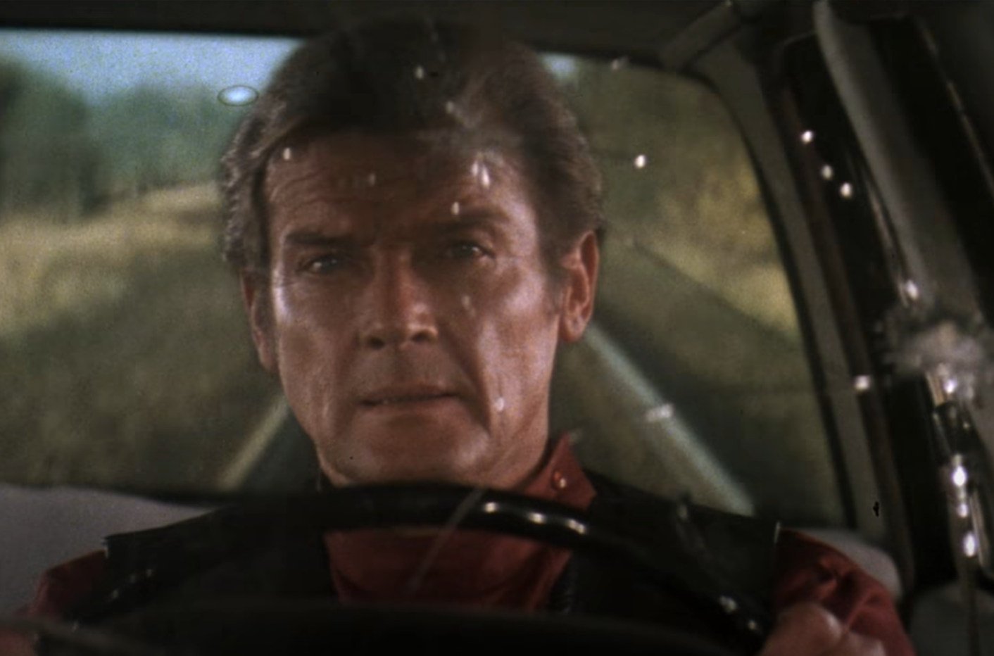 Screenshot of Roger Moore in car from Octopussy (1983)