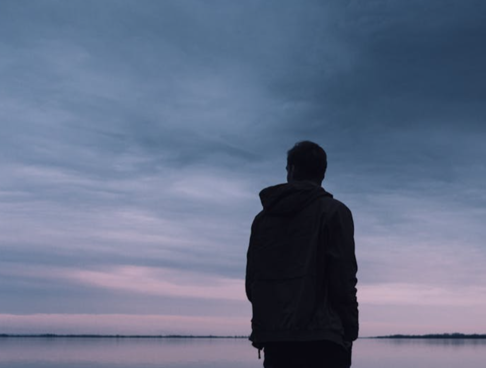 Person Standing Near Lake