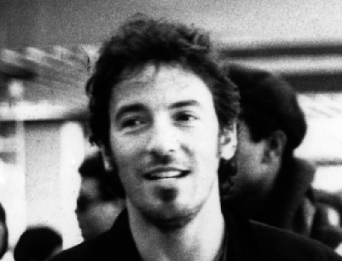 Grayscale Portrait Photo of Bruce Springsteen taken at an Airport