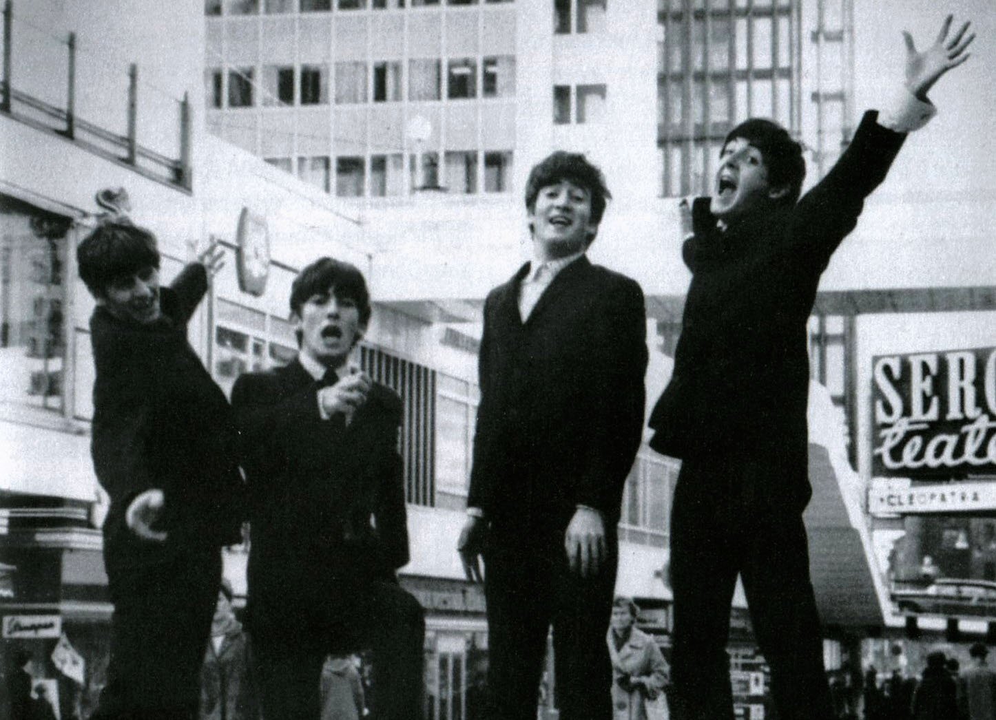 Grayscale Portrait Photo of The Beatles Jumping in the air in Hötorgscity