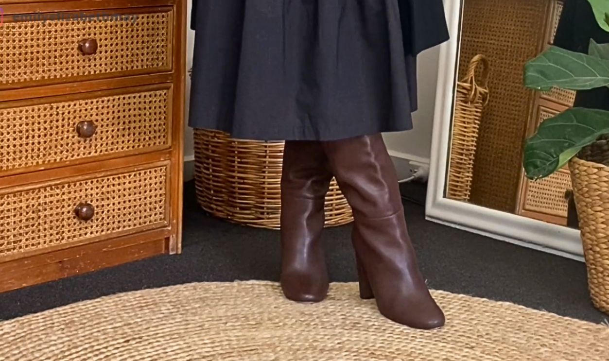 Brown Heeled Boots And A Black Midi Dress