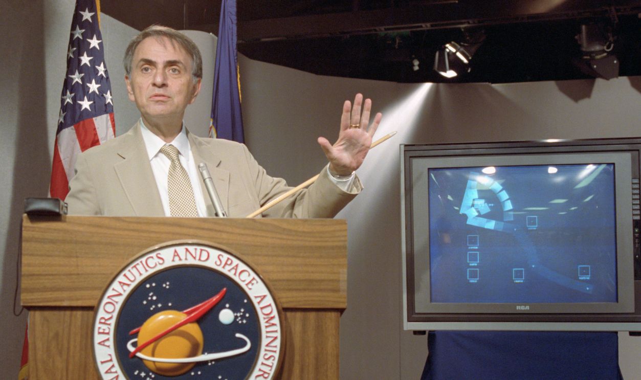 Gettyimages - 515327986, Carl Sagan Addressing Media Astronomer Carl Sagan Speaks at a news conference where NASA made available the last pictures taken by Voyager 1, which show the solar system as viewed from the outside.
