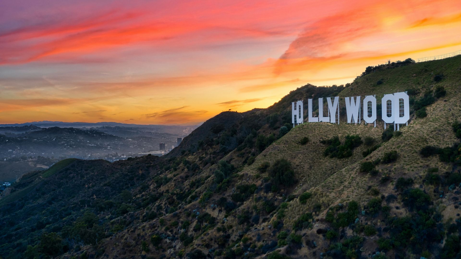 white concrete building on top of mountain during sunset