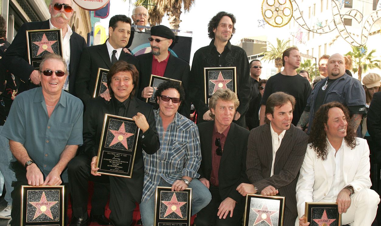 Back: George Tickner, Robert Fleischman, Steve Smith and Deen Castronovo Front: Aynsley Dunbar, Steve Perry, Neal Schon, Ross Valory, Jonathan Cain and Steve Augeri of Journey 