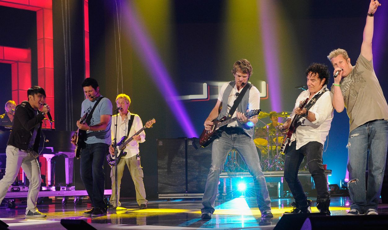(L-R) Journey members Arnel Pineda, Ross Valory (third from left), and Neal Schon (second from right) and Rascal Flatts members Jay DeMarcus (second from left), Joe Don Rooney (third from right), and Gary LeVox (far right) perform onstage during the 2012 CMT Music Awards rehearsal at Bridgestone Arena on June 5, 2012 in Nashville, Tennessee. 