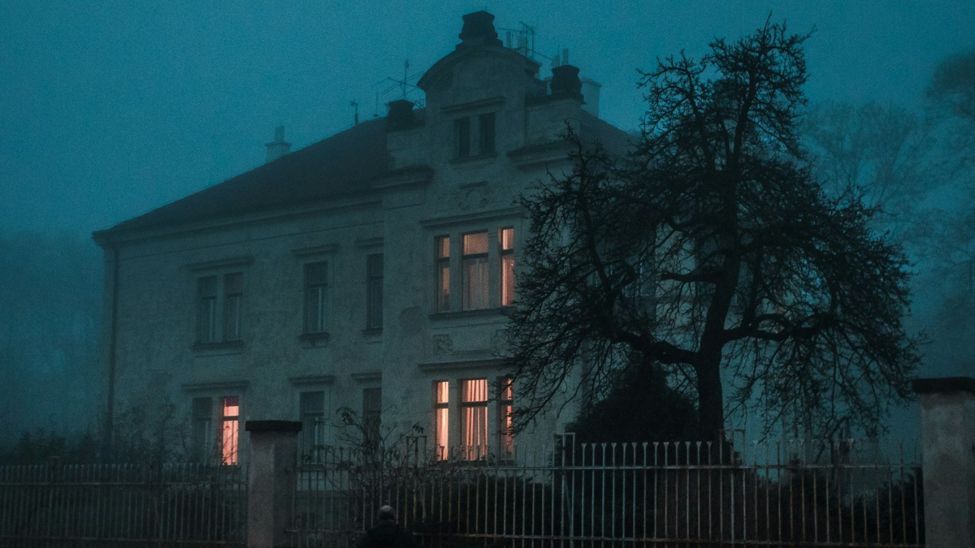 person walking towards house
