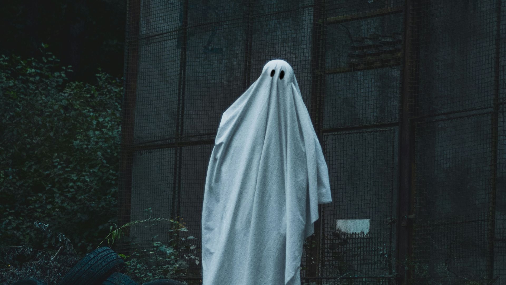 a white ghost standing in front of a building
