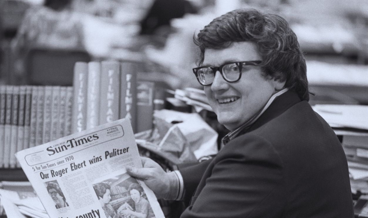 Gettyimages - 	515293384, Roger Ebert Roger Ebert, of the Chicago Sun-Times, whose film reviews are a feature of the Chicago paper and is syndicated to 100 other newspapers throughout the country holds a copy of the Sun-Times announcing his winning of the Pulitzer Prize for Criticism 5/5. 