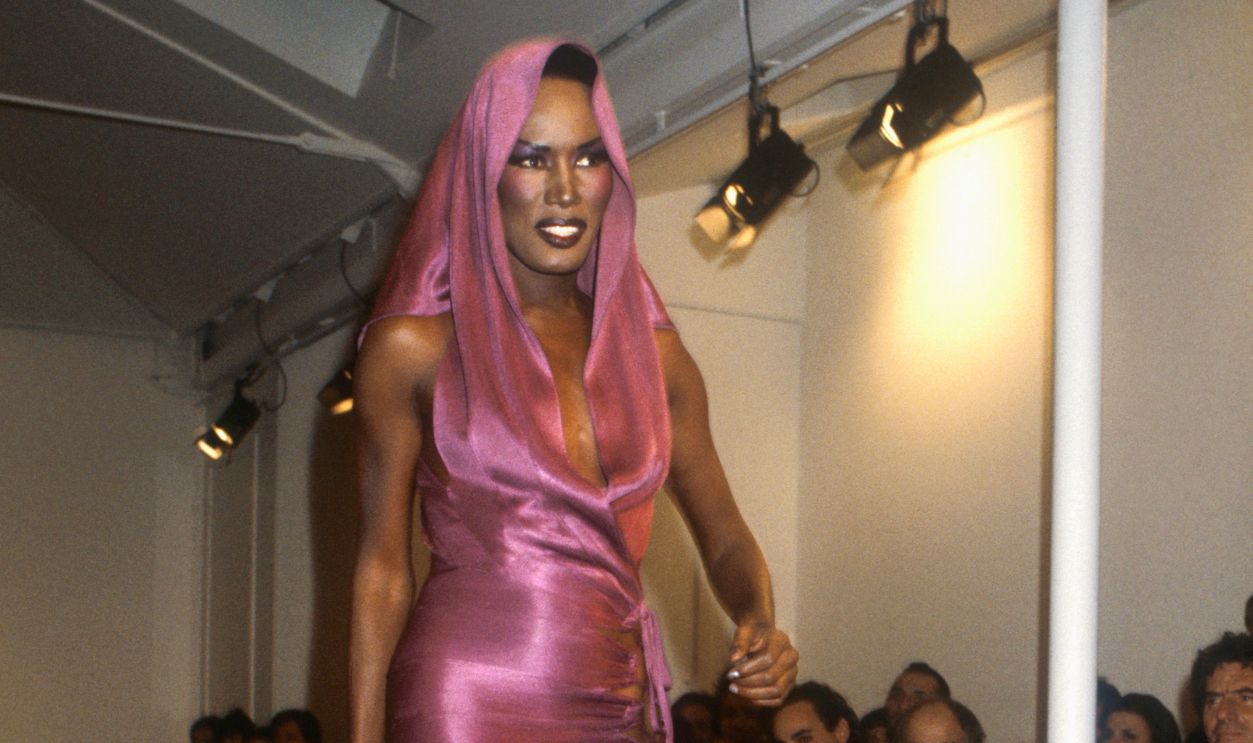 Tunisian designer Azzedline Alaia shows his women's 1986 spring-summer haute couture line in Paris. Model Grace Jones, also known for her singing and acting career, is wearing a clingy pink dress with an attached hood