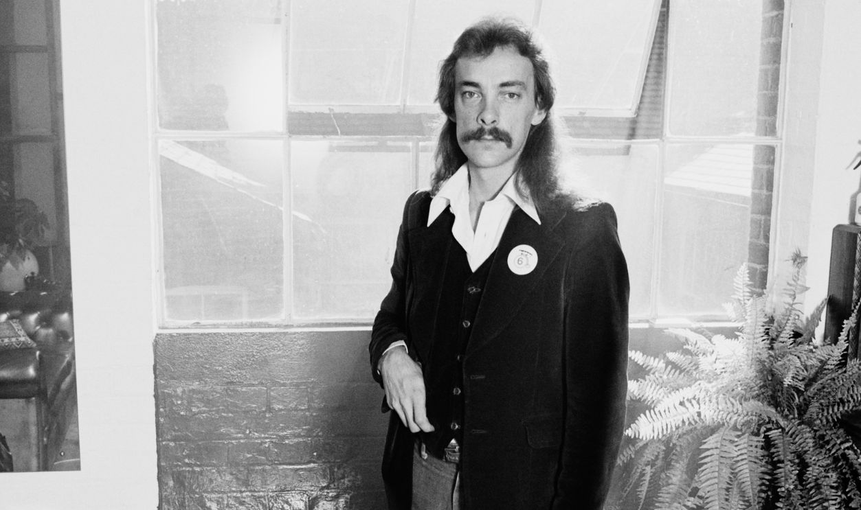 Gettyimages - 117077153, Neil Peart, Rush Drummer Full-length shot of Neil Peart, drummer with Canadian rock band Rush, poses in front of a window in a studio portrait, 1978.