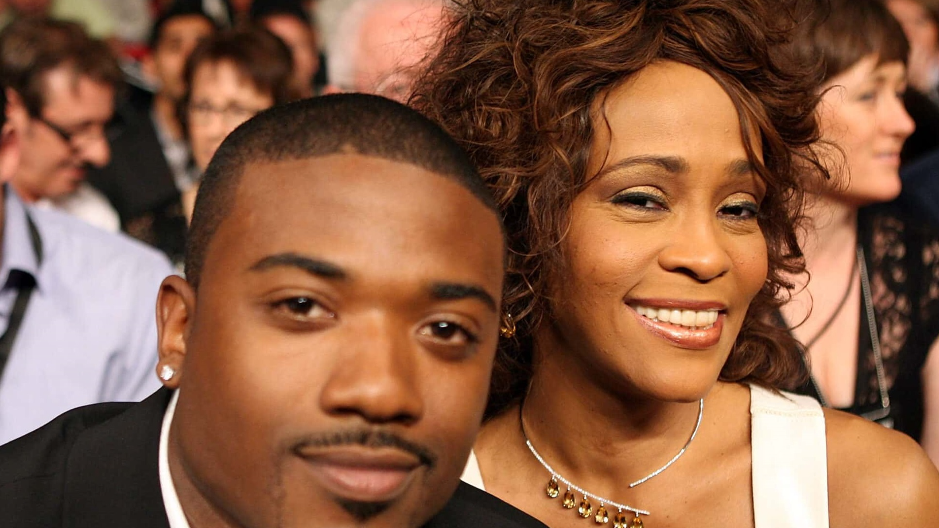 Whitney Houston and Ray-J are looking and smiling at camera - 2019