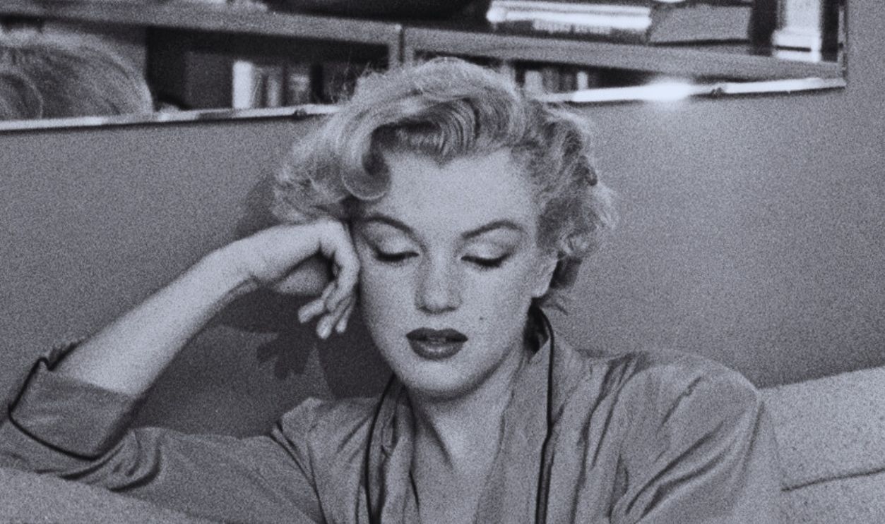 American actress Marilyn Monroe (1926 - 1962) relaxes on a sofa bed, circa 1951. The book she is reading is 'The Poetry and Prose of Heinrich Heine'.