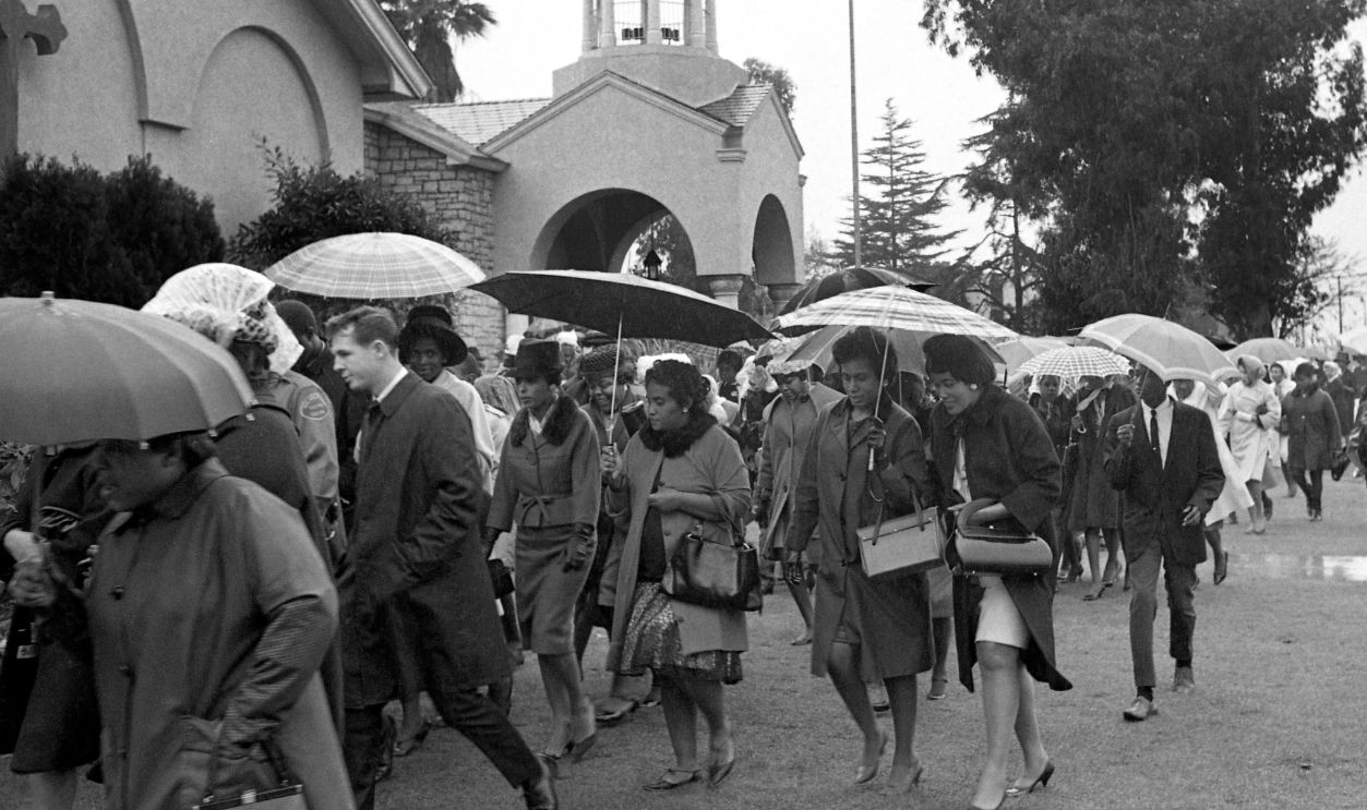 A portion of some 5,000 persons who paid final tribute to singer Sam Cooke are shown following services at Mr. Sinai Baptist Church 12/19. The crowd overflowed the church and many stood outside in a steady rain while the funeral was conducted for the popular 33-year-old singer