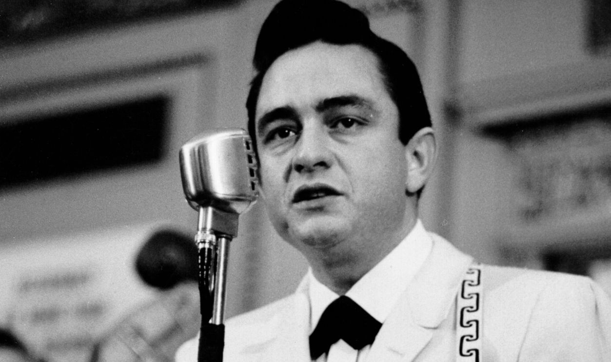 Country singer Johnny Cash performs onstage with an acoustic guitar in circa 1958.