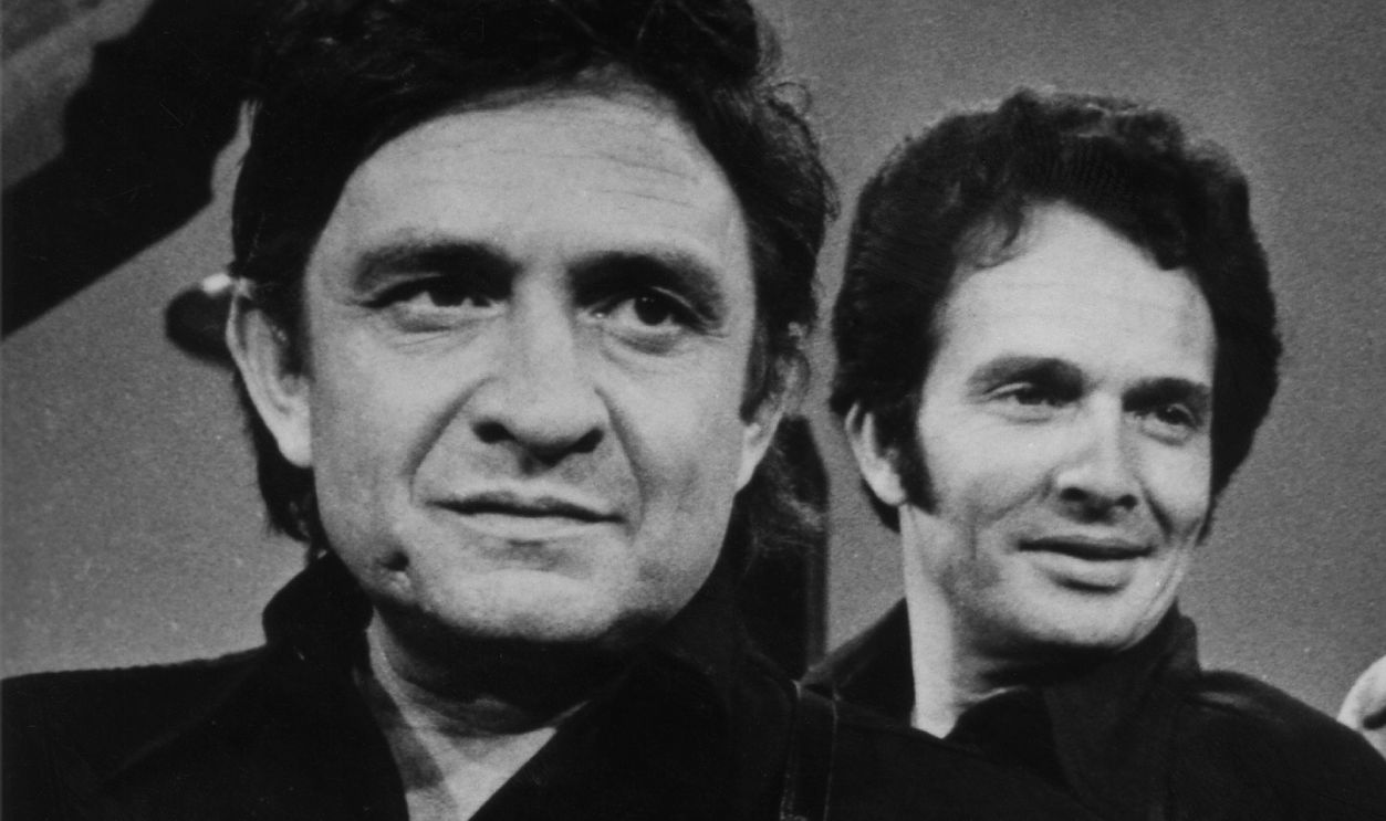  (L-R) Country musician Johnny Cash, Merle Haggard, Buck Owens and Glen Campbell perform on stage during a mid 1970's performance for a TV show. 