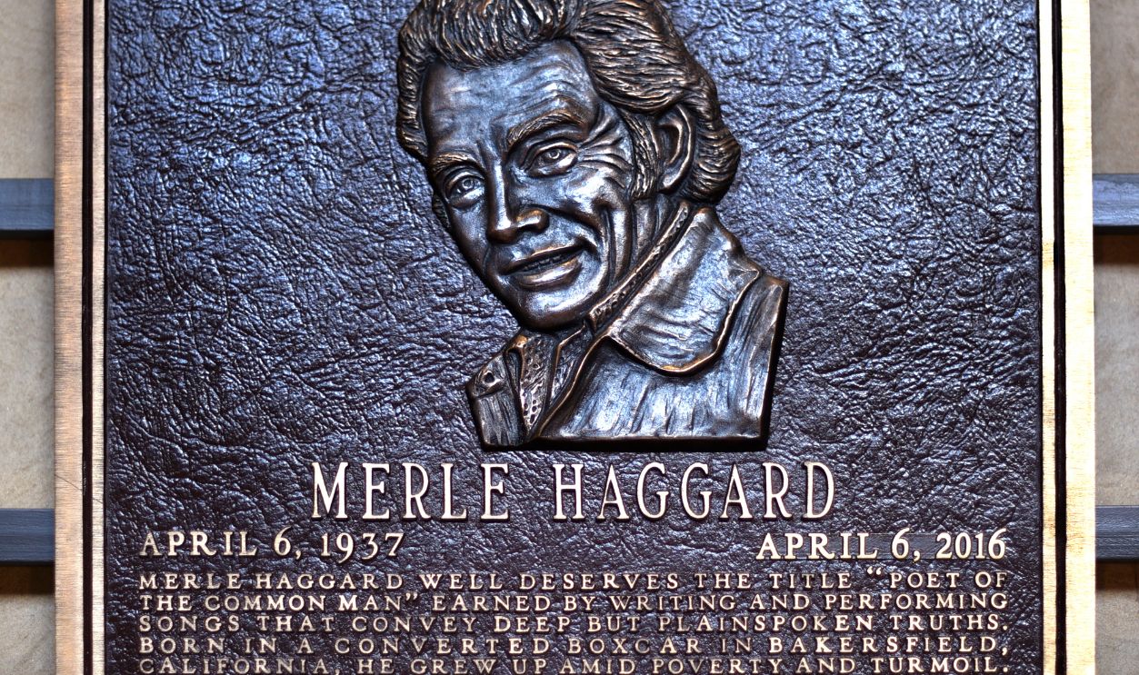 A bronze plaque at the Country Music Hall of Fame and Museum in Nashville, Tennessee, honors Hall of Fame member Merle Haggard. Country Music Hall of Fame inductees are chosen each year by a panel of country music industry leaders chosen by the Country Music Association.