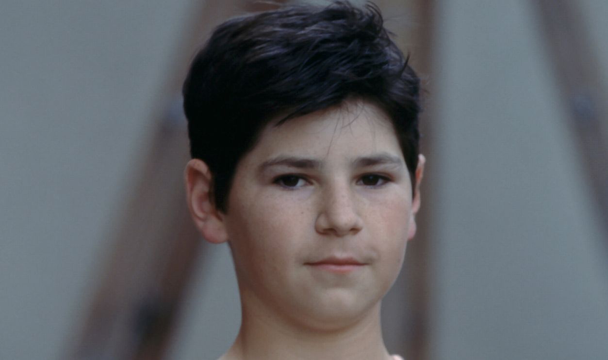 Michael Fishman Portrait Session LOS ANGELES, CA - 1990: Actor Michael Fishman, D.J. Conner from T.V. show 'Roseanne', poses for a portrait on the lot outside of the soundstage for