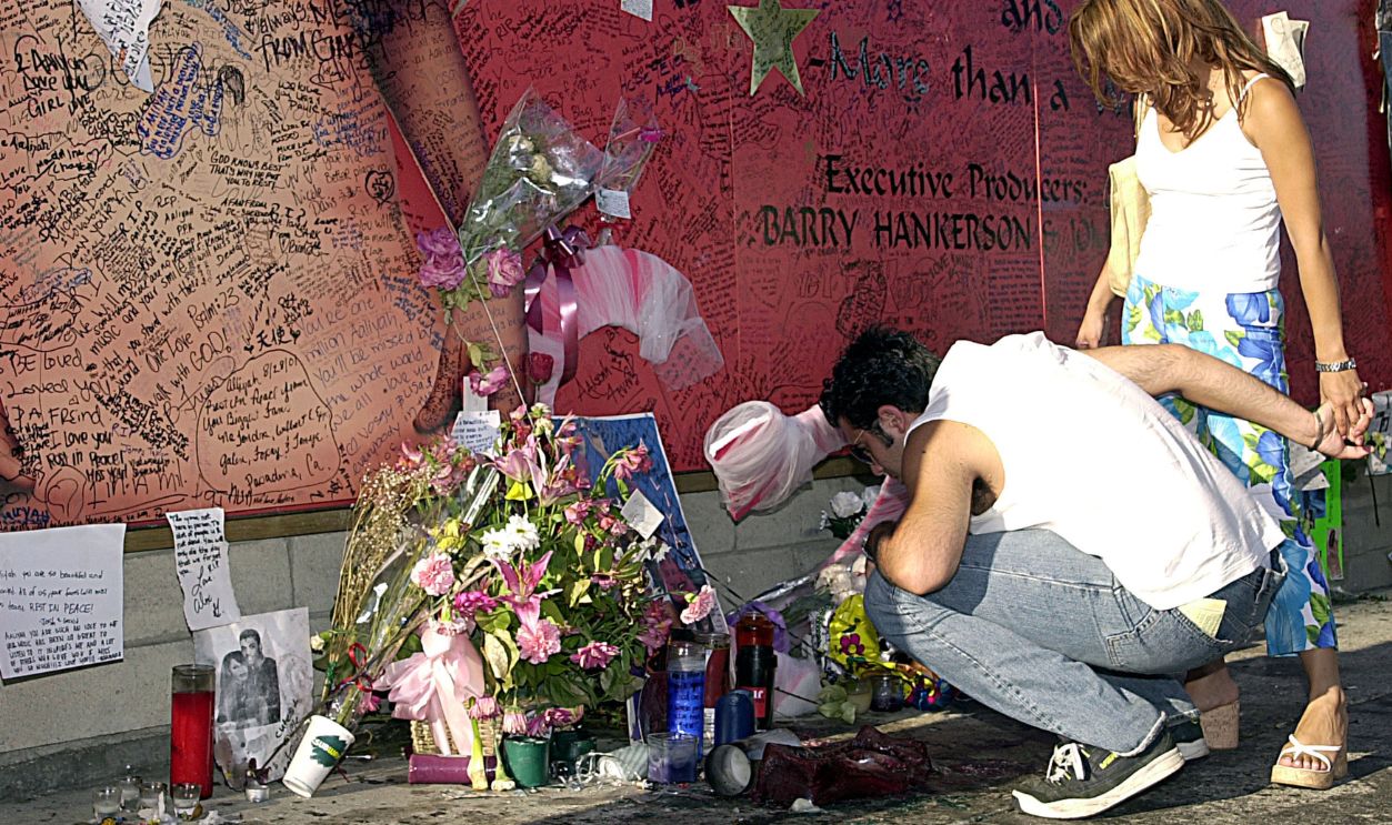 Gettyimages - 104723810, Aaliyah Fans Sign Mural In Tribute Fans of R&B singer/actress Aaliyah looks on at a record store mural of the late singer in what has a become shrine dedicated to her after her death in a plane crash in the Bahamas.