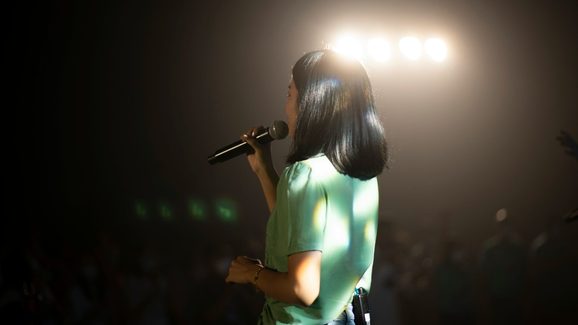 a person singing into a microphone