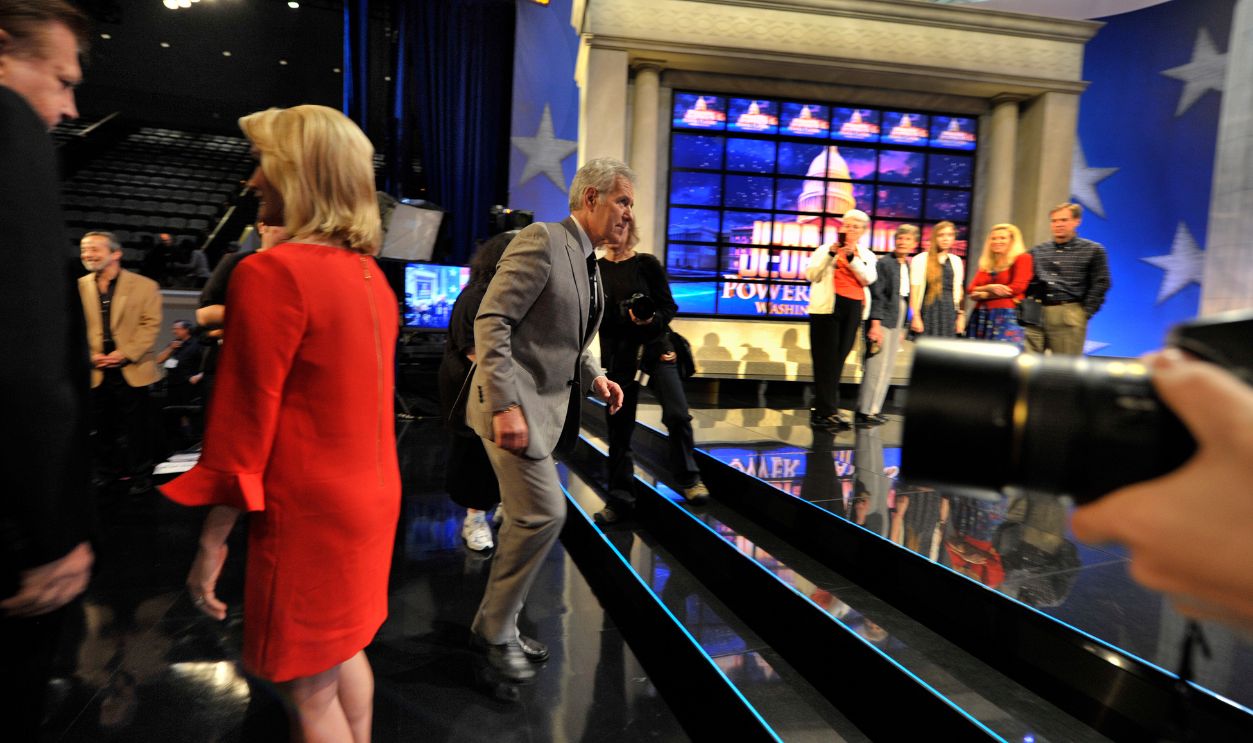 WASHINGTON, DC - APRIL 21: Jeopardy host Alex Trebek (C) moves between photo ops on the set of Jeopardy in Washington on April 21, 2012. Jeopardy's host Alex Trebek was in Washington for his 'Jeopardy! Power Players Week' shows which were being filmed inside DAR Constitution Hall.