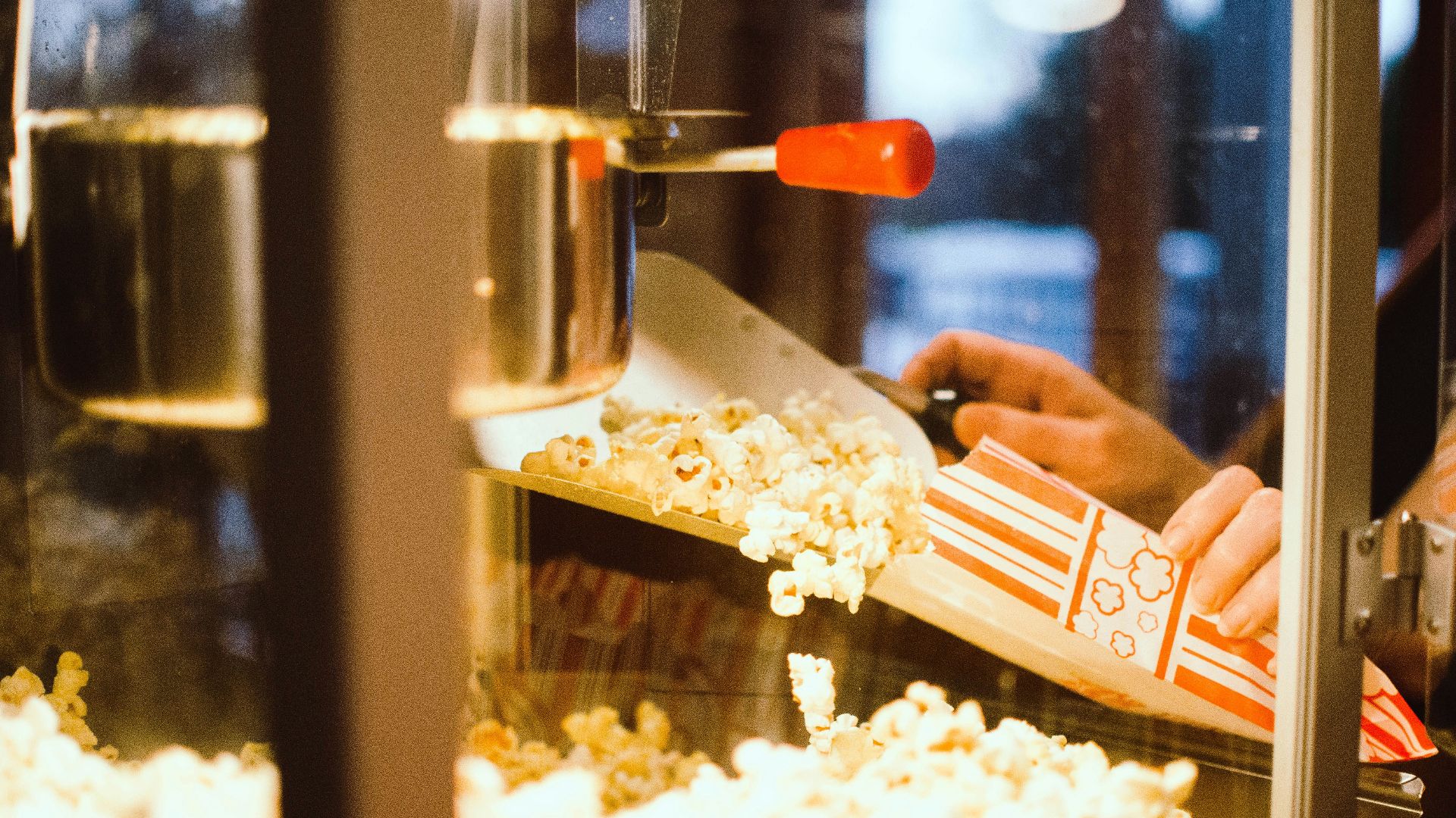 person holding red and white plastic container
