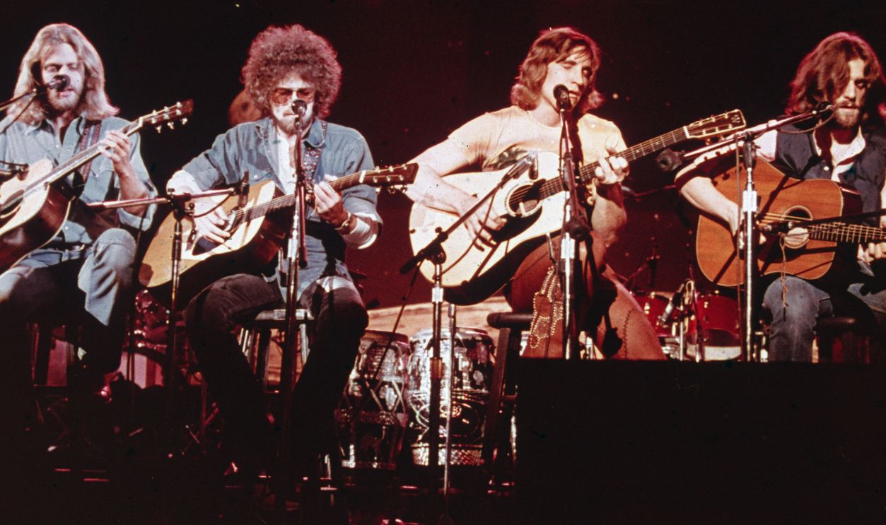 Members of the American soft-rock ensemble The Eagles sit on chairs as they perform on the television show 'Don Kirschner's Rock Concert,' 1979. Band Members are (left to right) Glenn Frey, Don Henley, Joe Walsh, and Don Felder. 