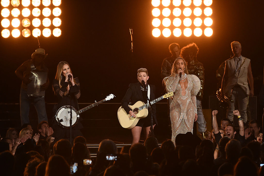 Beyonce (R) performs onstage with Emily Robison and Natalie Maines of Dixie Chicks