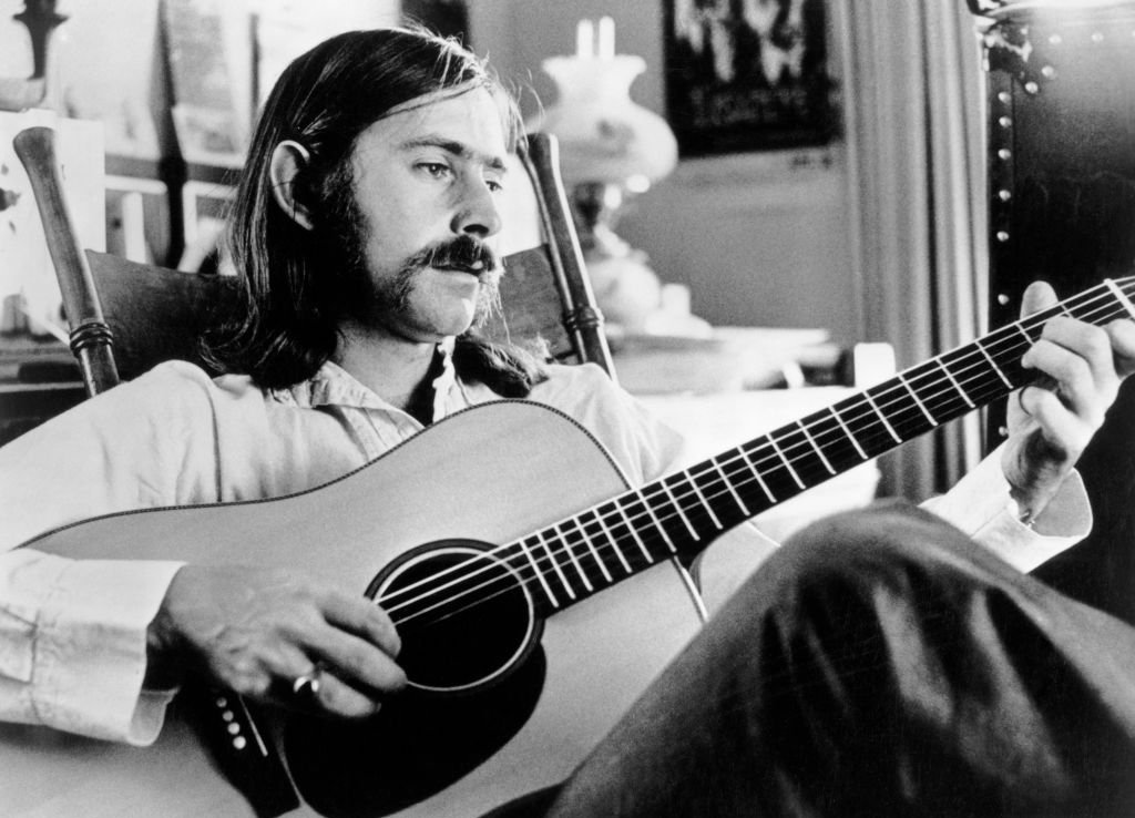 Norman Greenbaum playing on an acoustic guitar