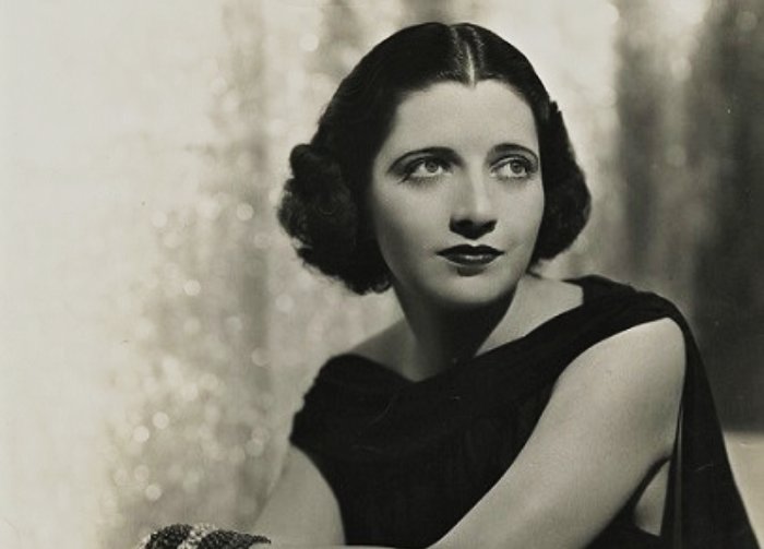 Kay Francis wearing black top and looking away from the camera