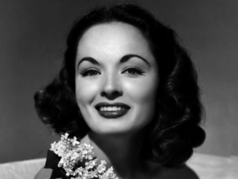 Promotional photograph of Ann Blyth with white flower