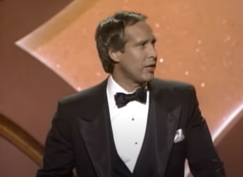 Host Chevy Chase performs onstage during the Annual Academy Awards