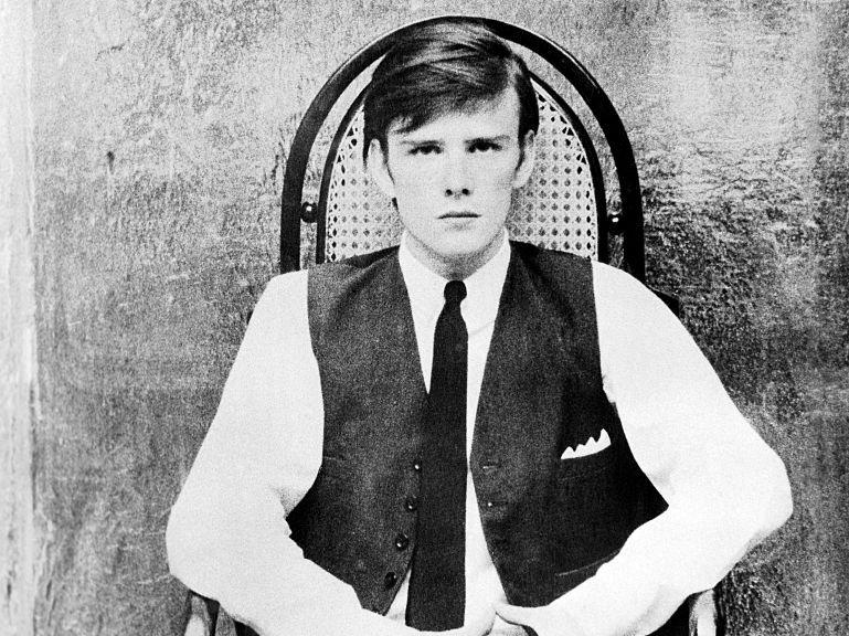 Grayscale Portrait Photo of Stuart Sutcliffe facing the camera
