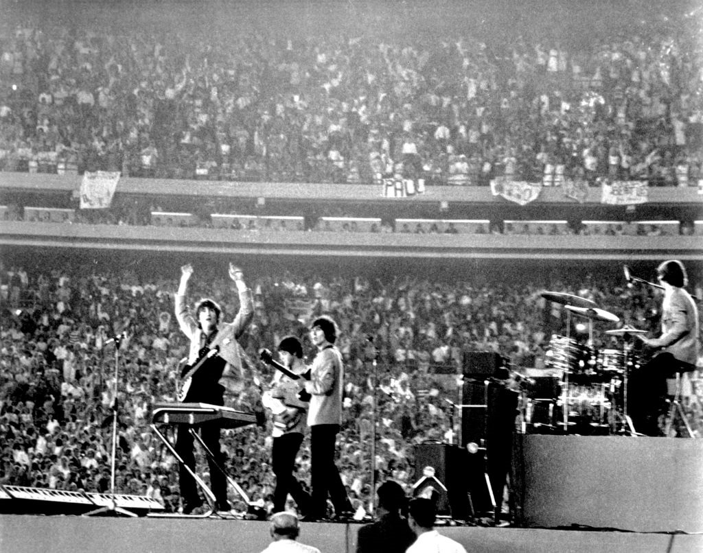 The Beatles perform at Shea Stadium, New York on 15th August 1965.